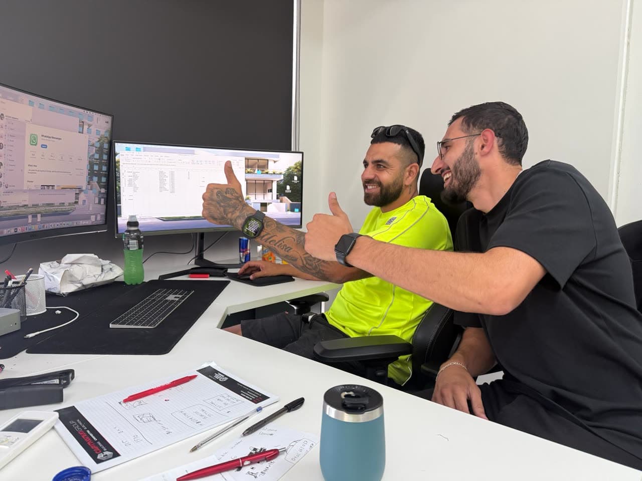 Moe Dhaini and Moe Ali Hijazi at the CCC office, reviewing build plans and the agent's work together